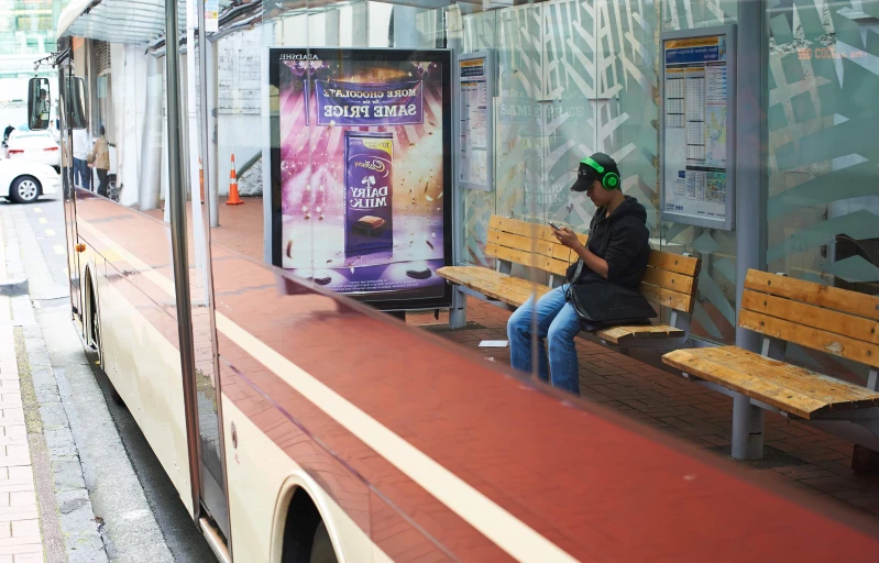 a woman on her cell phone while waiting for the bus