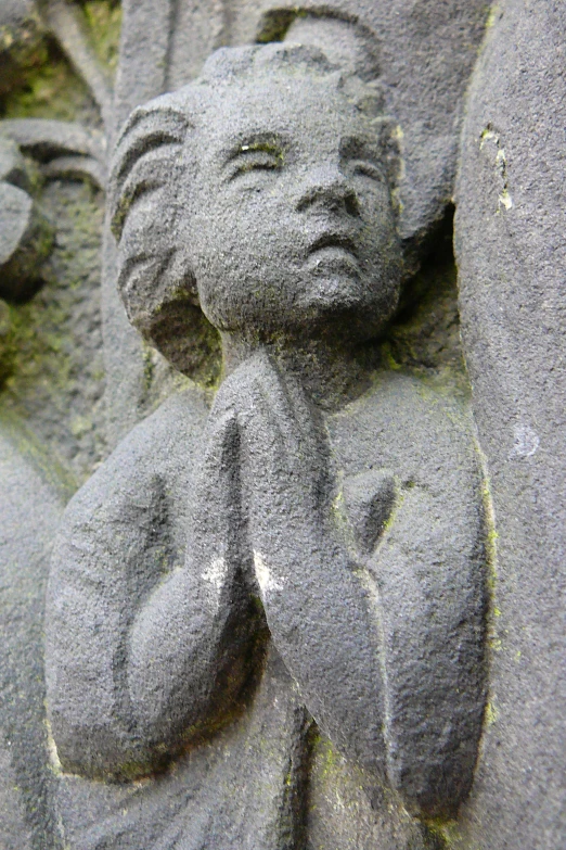 two garudes and an angel are depicted on a stone wall