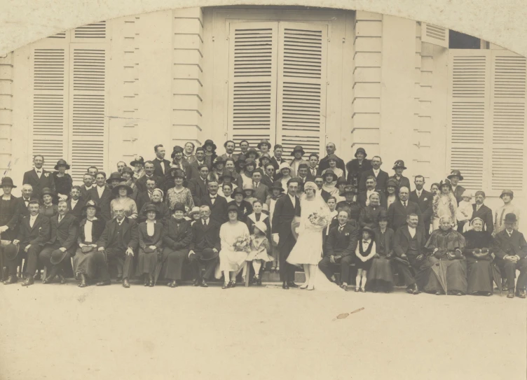 a black and white po of people posing for a wedding pograph