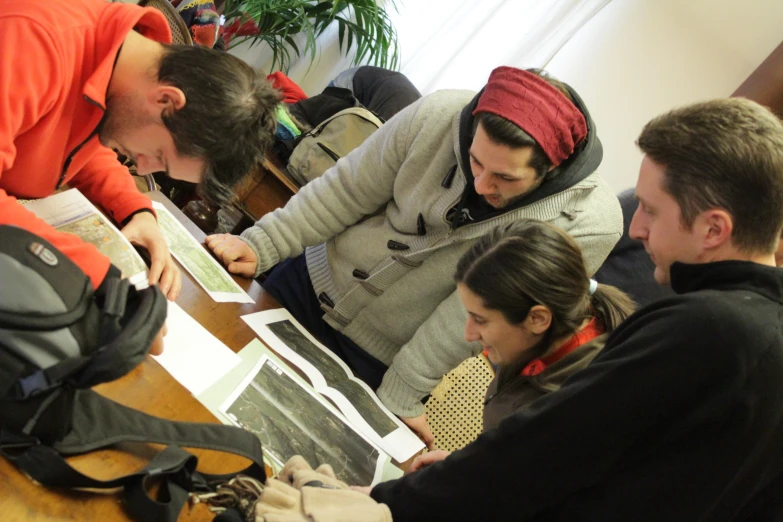 people look at an open notebook on a table