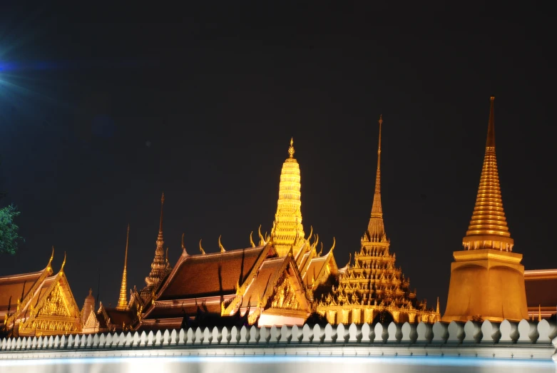 a lighted temple in the night with its spires illuminated