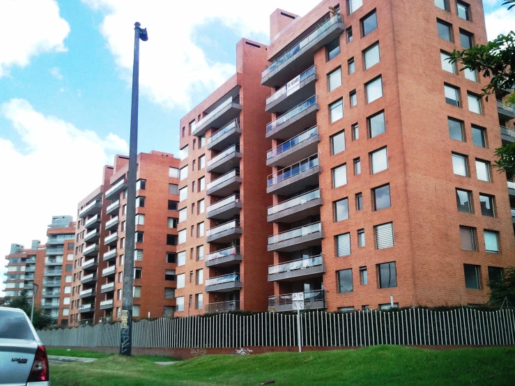 two cars parked in front of a multi story building