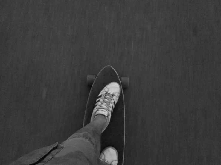 a person riding a skateboard with their feet hanging back