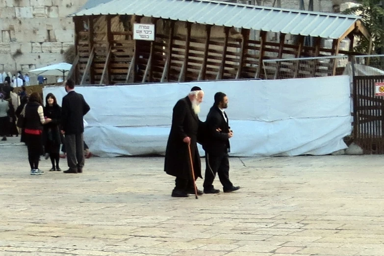 two men in black robes talking together