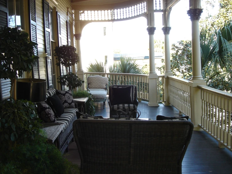 a big porch with a lot of couches on it