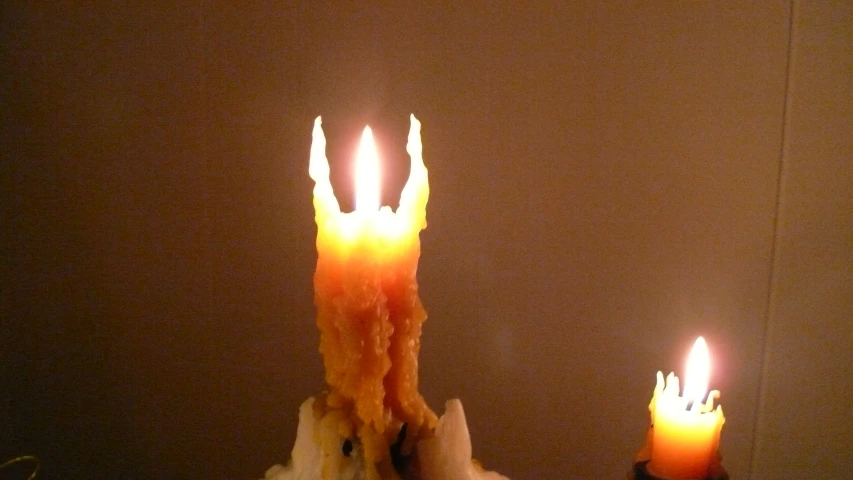 the candle is lit, and the man appears to have fallen his arm