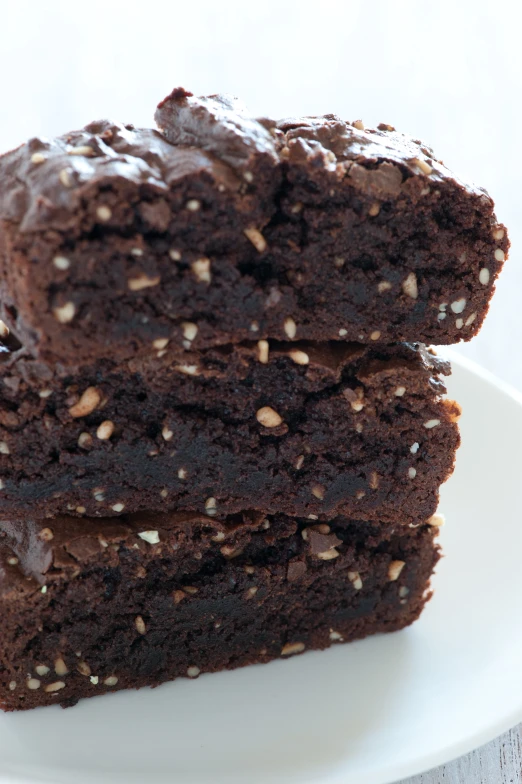 two pieces of chocolate brownies sit on a plate