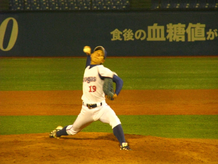 an athlete pitching a baseball on a field