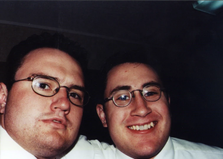 two men are posing for the camera with glasses on