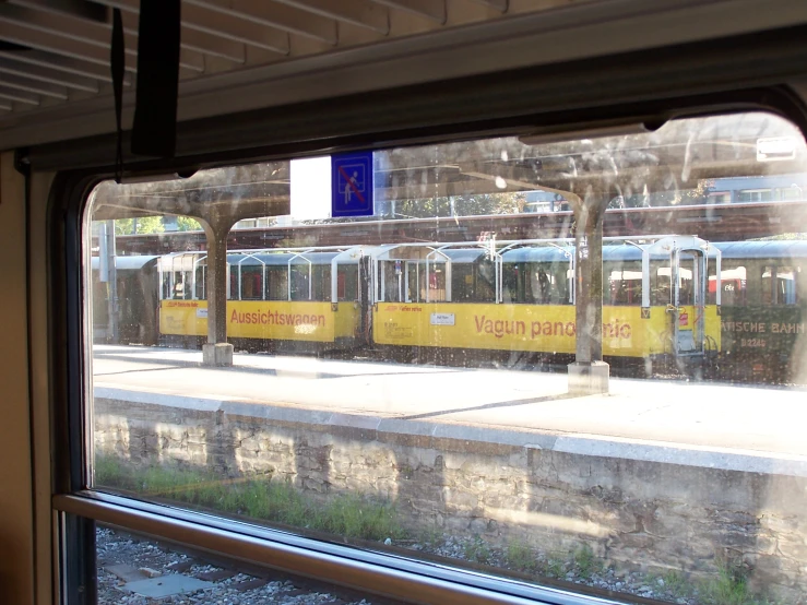 a yellow subway car at the end of a train track