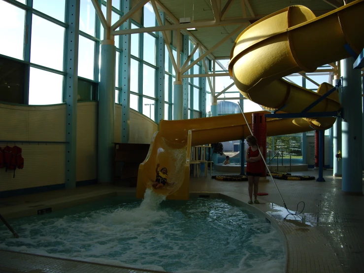 there is a large yellow slide in the water