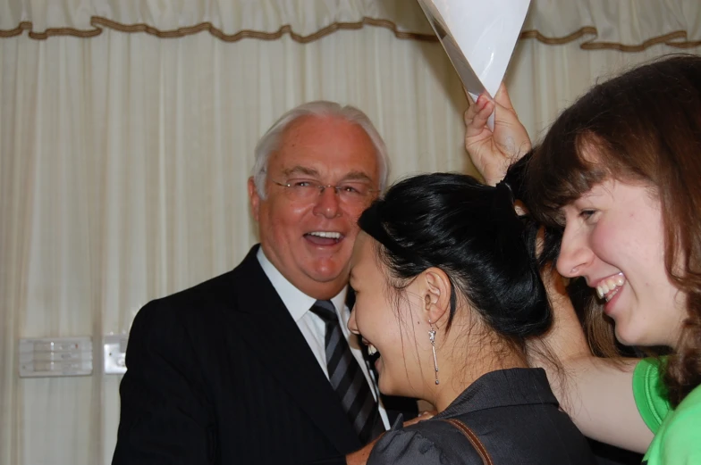 two men and one woman sharing a laugh together