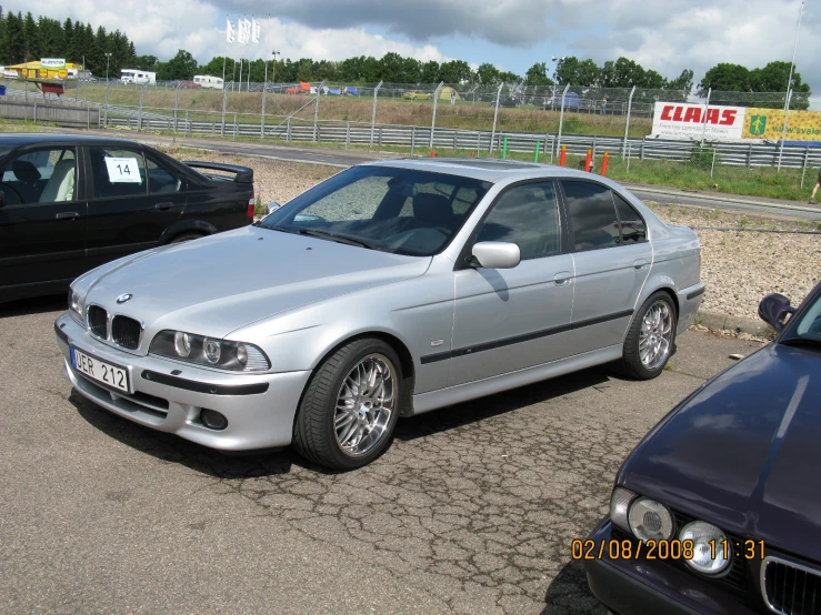 silver bmw car in parking lot with other cars