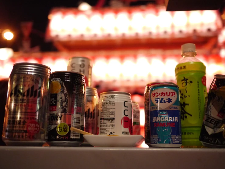 several cans of soda and two cups on the table