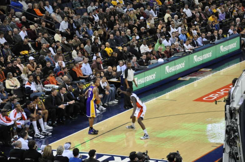 two men on a court with many people watching