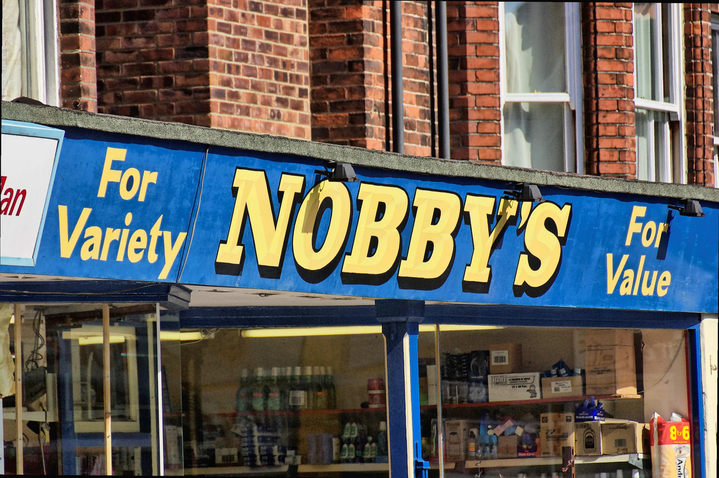 a store front in a city with brick buildings