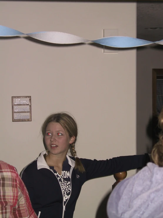 a woman holding a wii remote to her ear