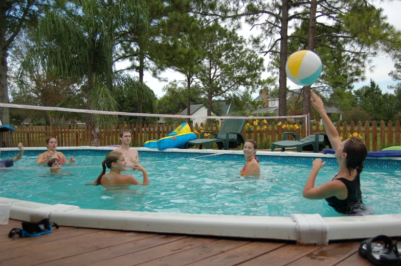 some people playing volleyball in the water