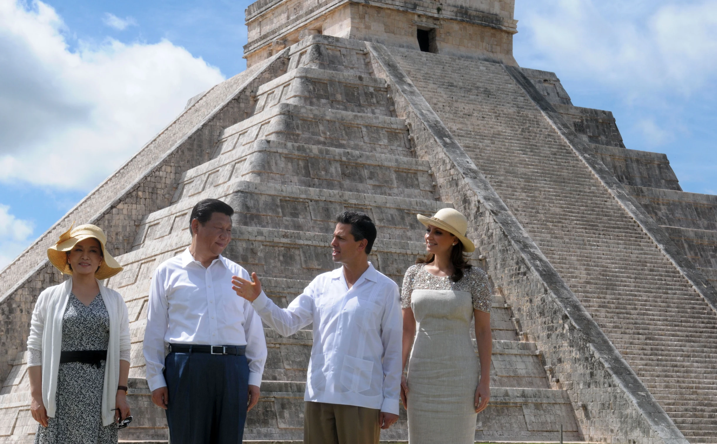 four people in front of an ancient building