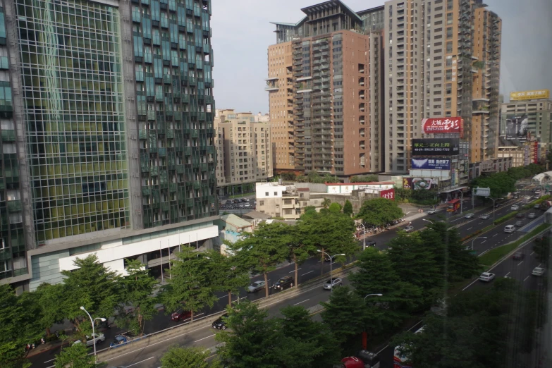 a city with lots of tall buildings and green trees