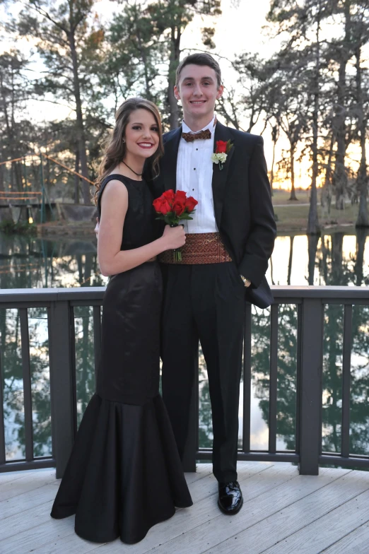 a beautiful young woman standing next to a man