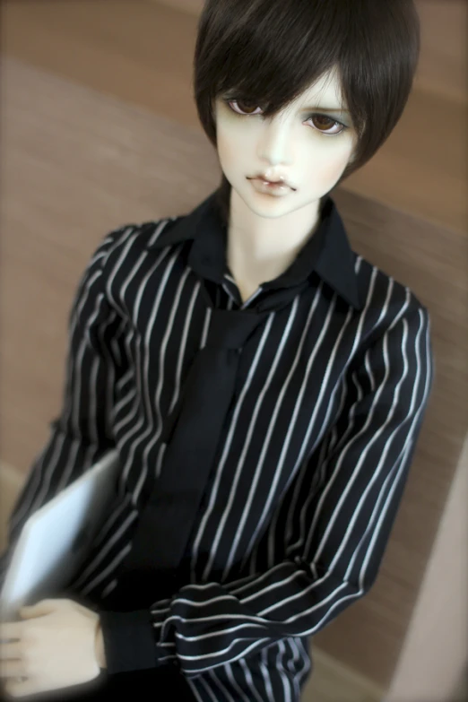 a doll is dressed in a striped shirt