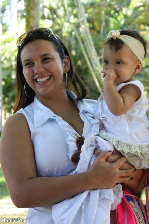 two ladies posing with their baby girl