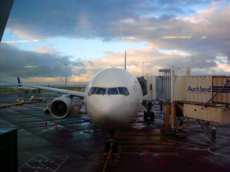 an air plane at the airport with the back door open