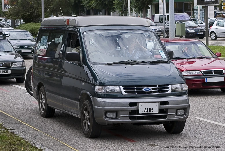 a car is driving around some parked cars