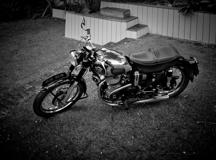 black and white pograph of a motorcycle parked on a lawn
