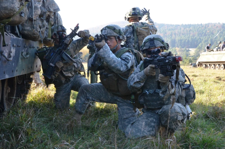 a group of soldiers with weapons and camouflage gear taking position