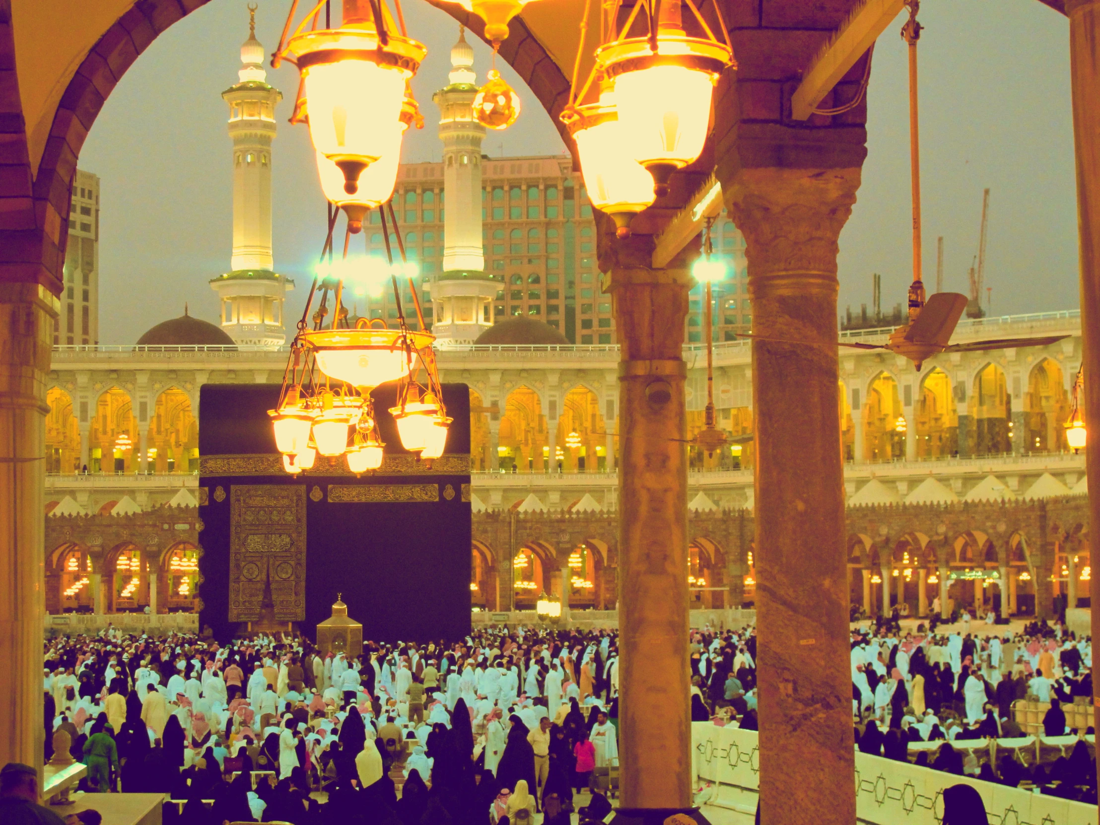 many people are gathered in a large, ornate courtyard