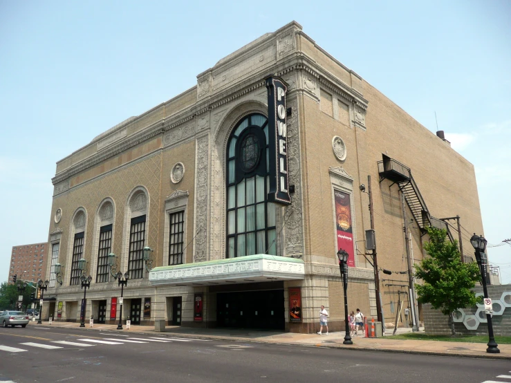 a brown brick theater building sits on the corner