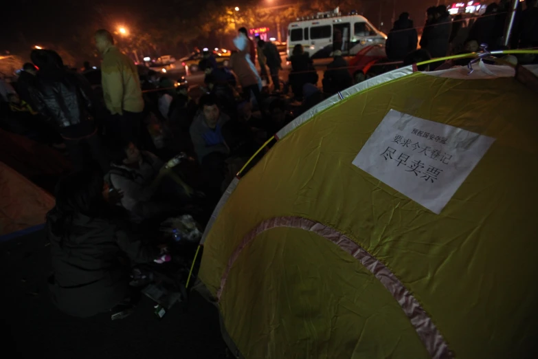 several tents are in the dark with people inside