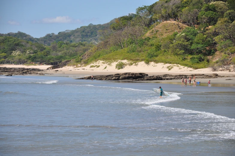 a man standing on top of a surfboard in the ocean