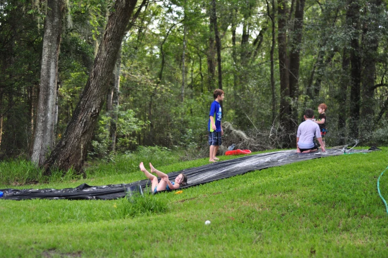 three people having fun playing in a field with their swimming equipment