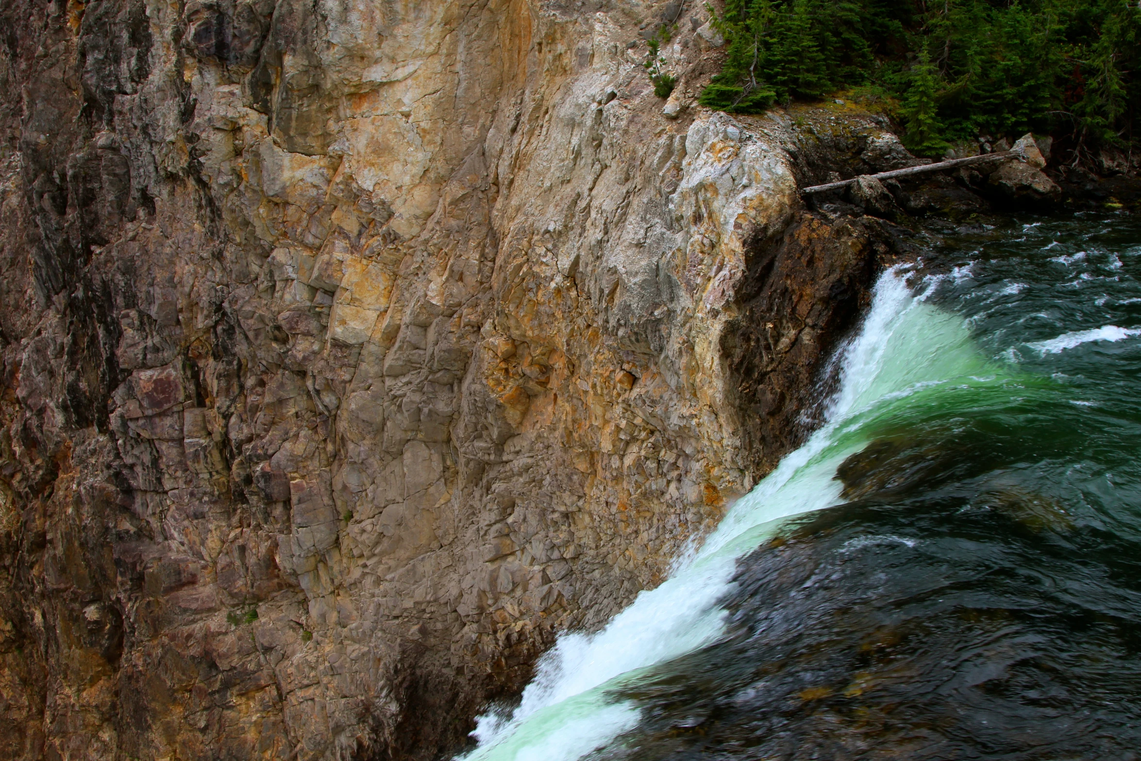 a close up of a cliff with water