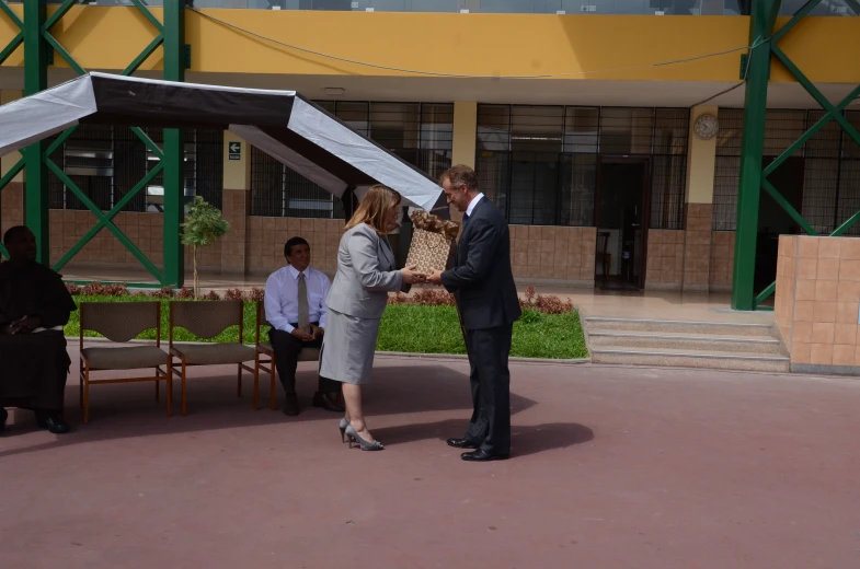 a man in a suit shakes a women hand