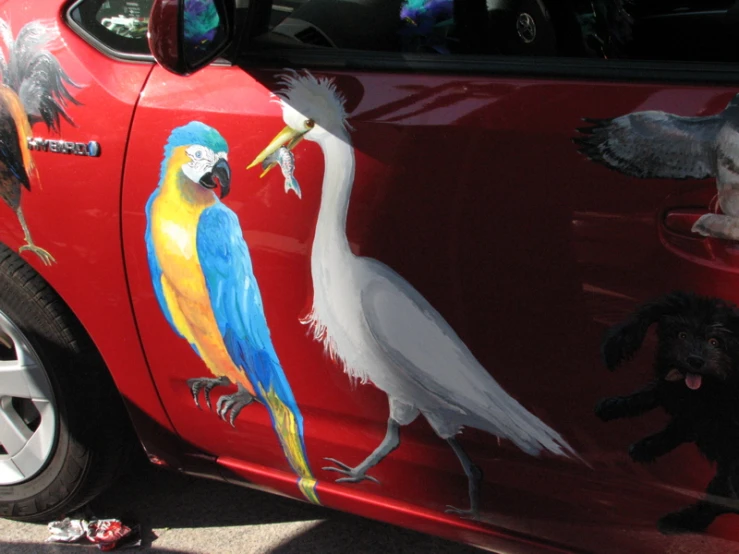 a car with the door open and painted with a picture of animals on it