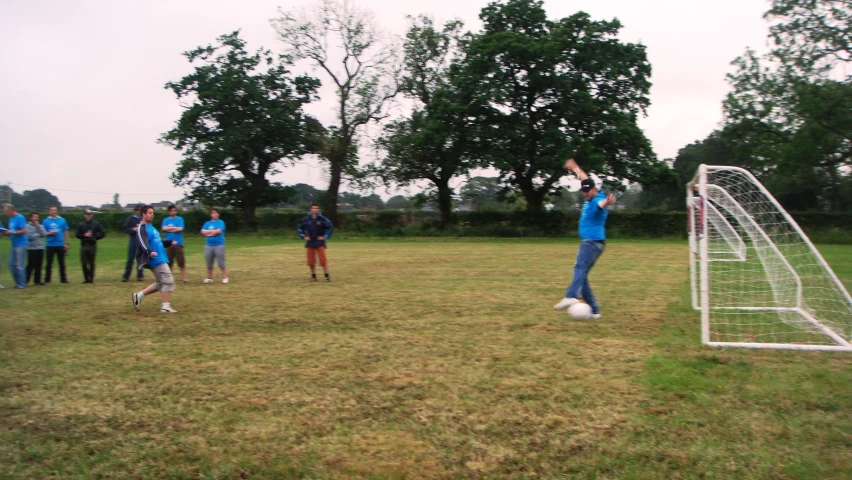 a couple of people standing next to a soccer goal