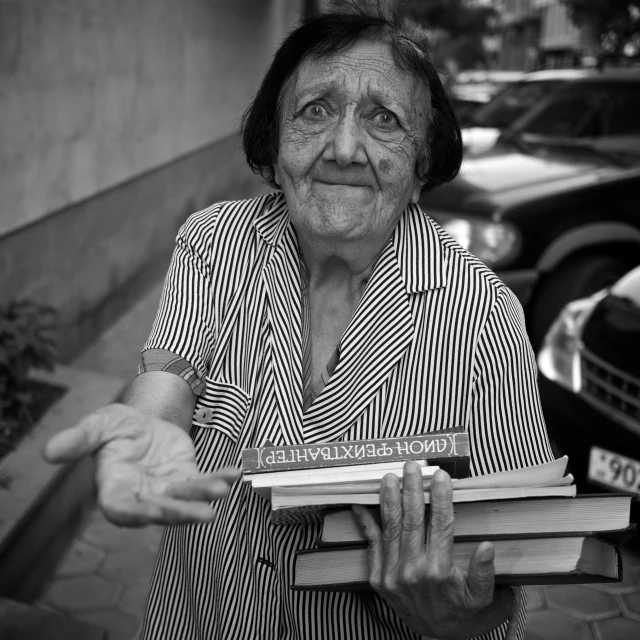 a black and white po of an older woman carrying books
