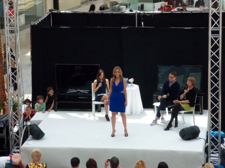 people at an event on stage with fashion show