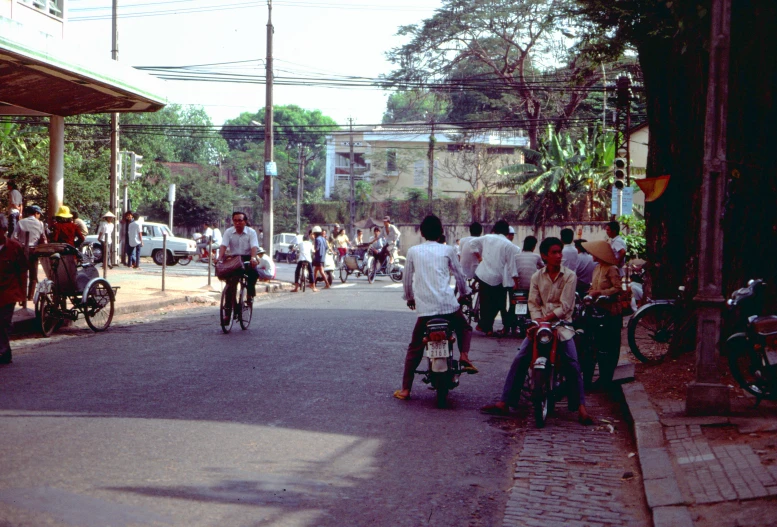 the bike riders are riding down the street