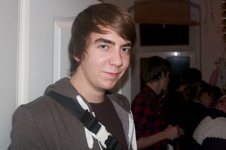 a young man standing in front of a group of people