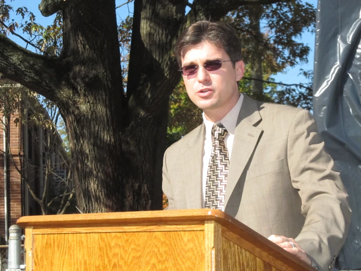 a young man in a suit and tie speaking