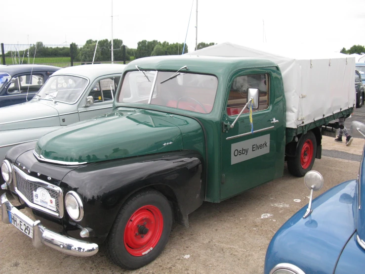 an old truck with an awning at a show