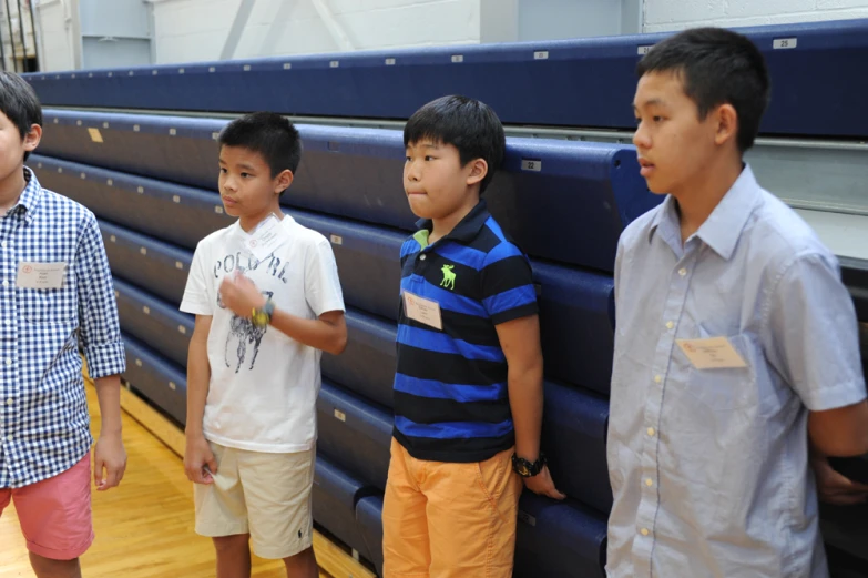 four s standing next to a blue wall