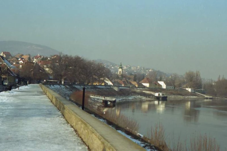 the street is in the snow near the river