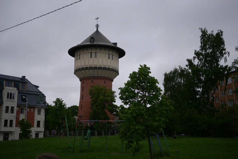 a tall, tall brick tower with a cross on top