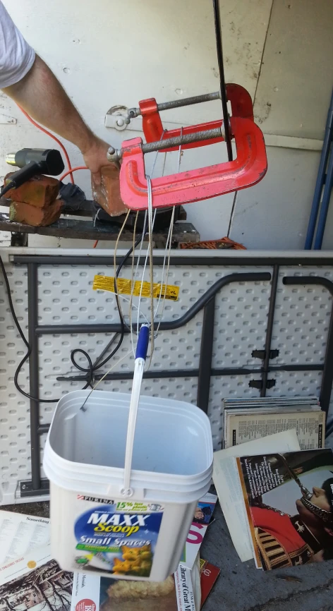 a bucket is filled with newspapers next to a handmade sled